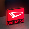 Daihatsu LED lightbox standing on a desk from an angled side view with red glow