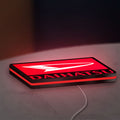 Daihatsu LED lightbox lying flat on a desk with red glow