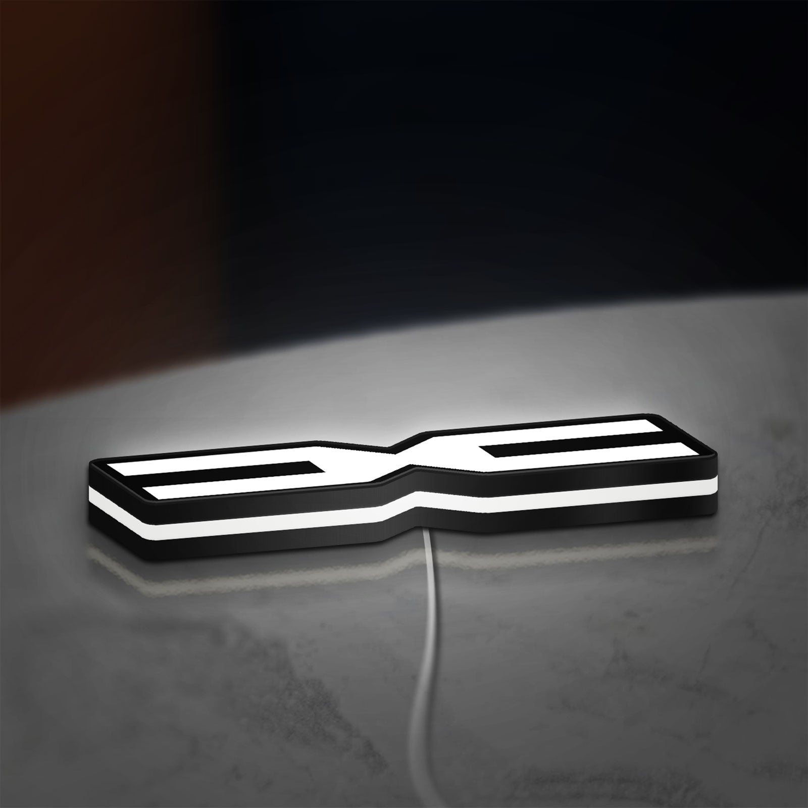 Dacia 2021 LED lightbox lying flat on a desk with white glow