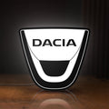 Front view of Dacia LED lightbox sign glowing on a wooden desk