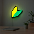 JDM Wakaba Leaf LED lightbox hanging on a room wall with soft green light