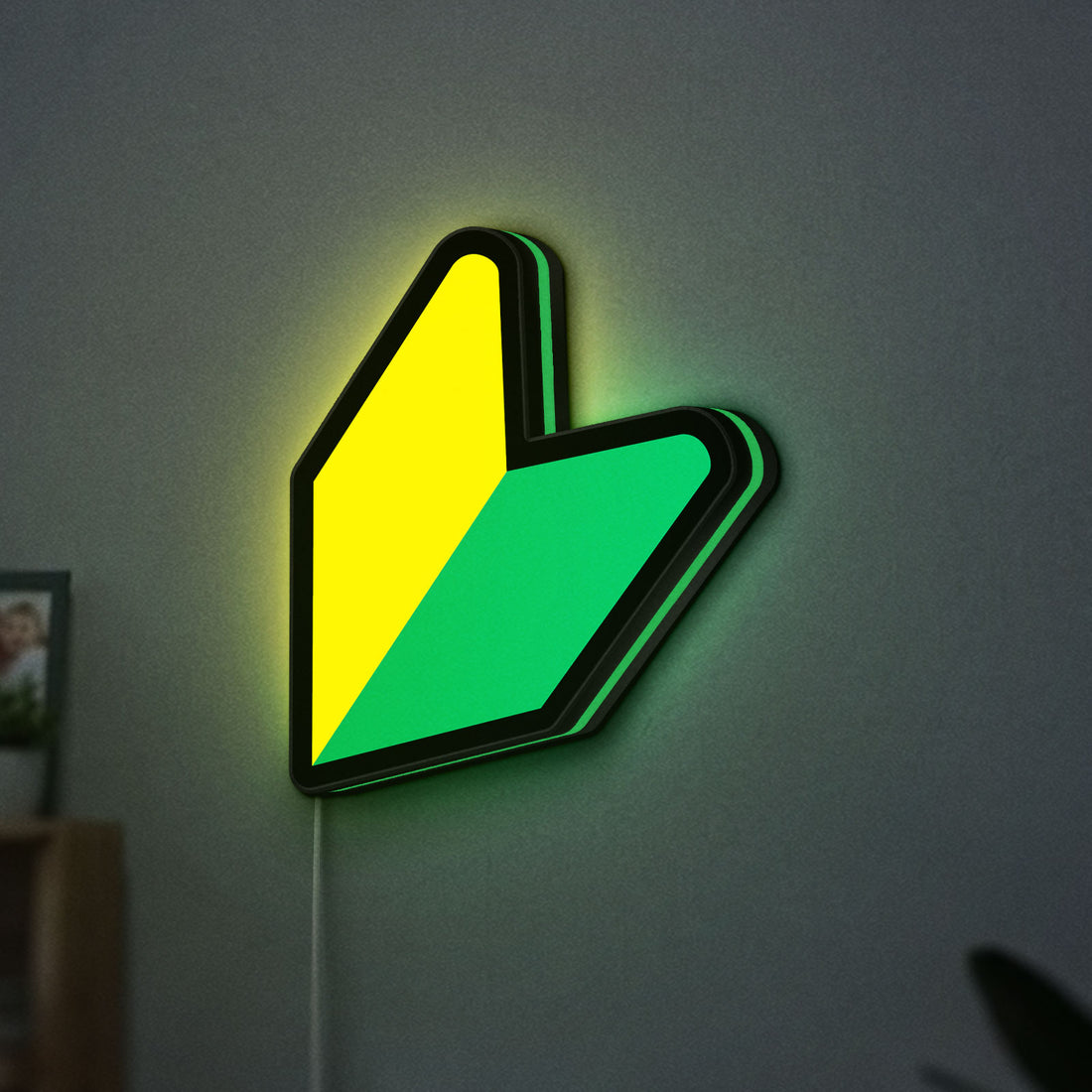 JDM Wakaba Leaf LED lightbox hanging on a wall with green glow