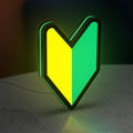 JDM Wakaba Leaf LED lightbox standing on a desk from an angled side view with green glow