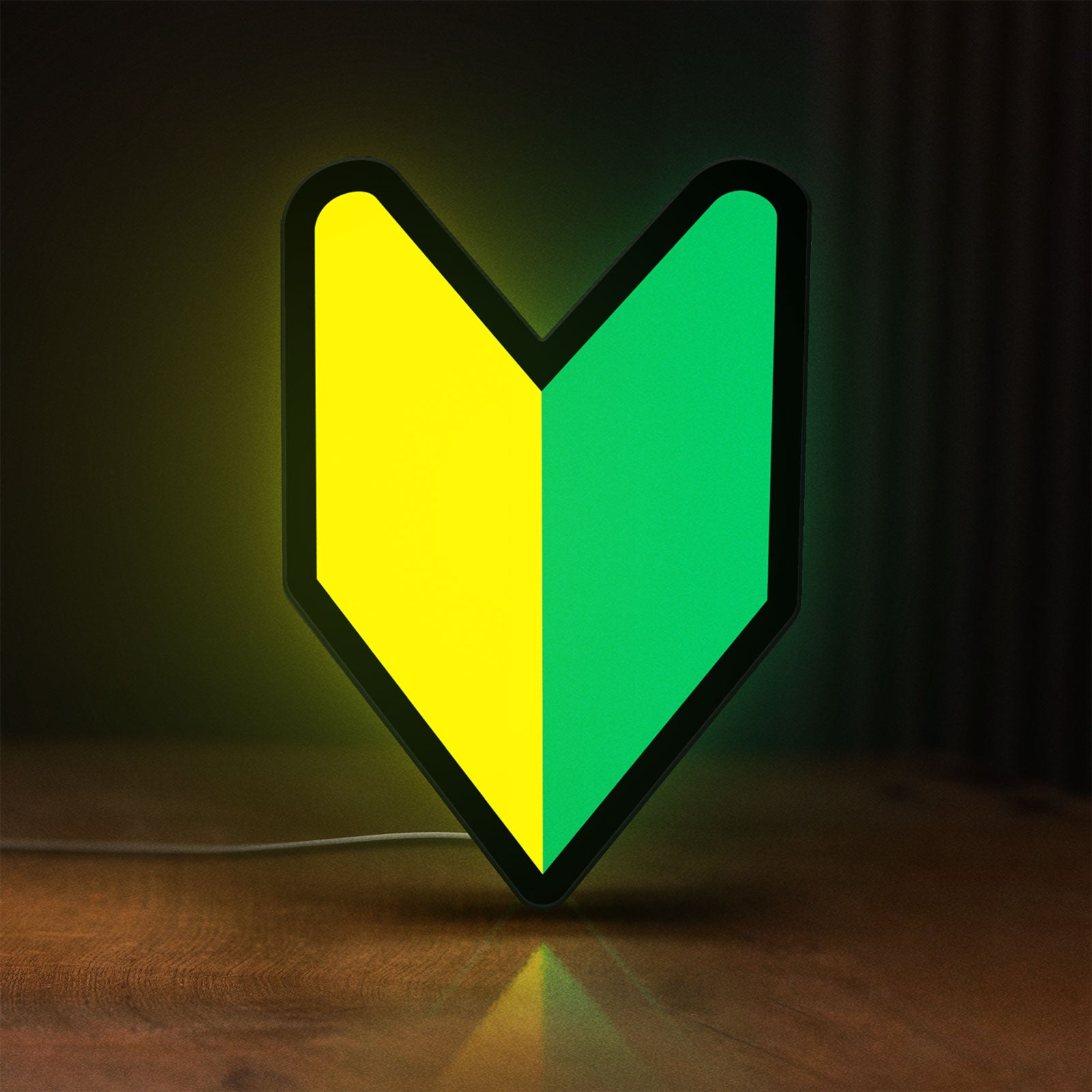 Front view of JDM Wakaba Leaf LED lightbox sign glowing on a wooden desk