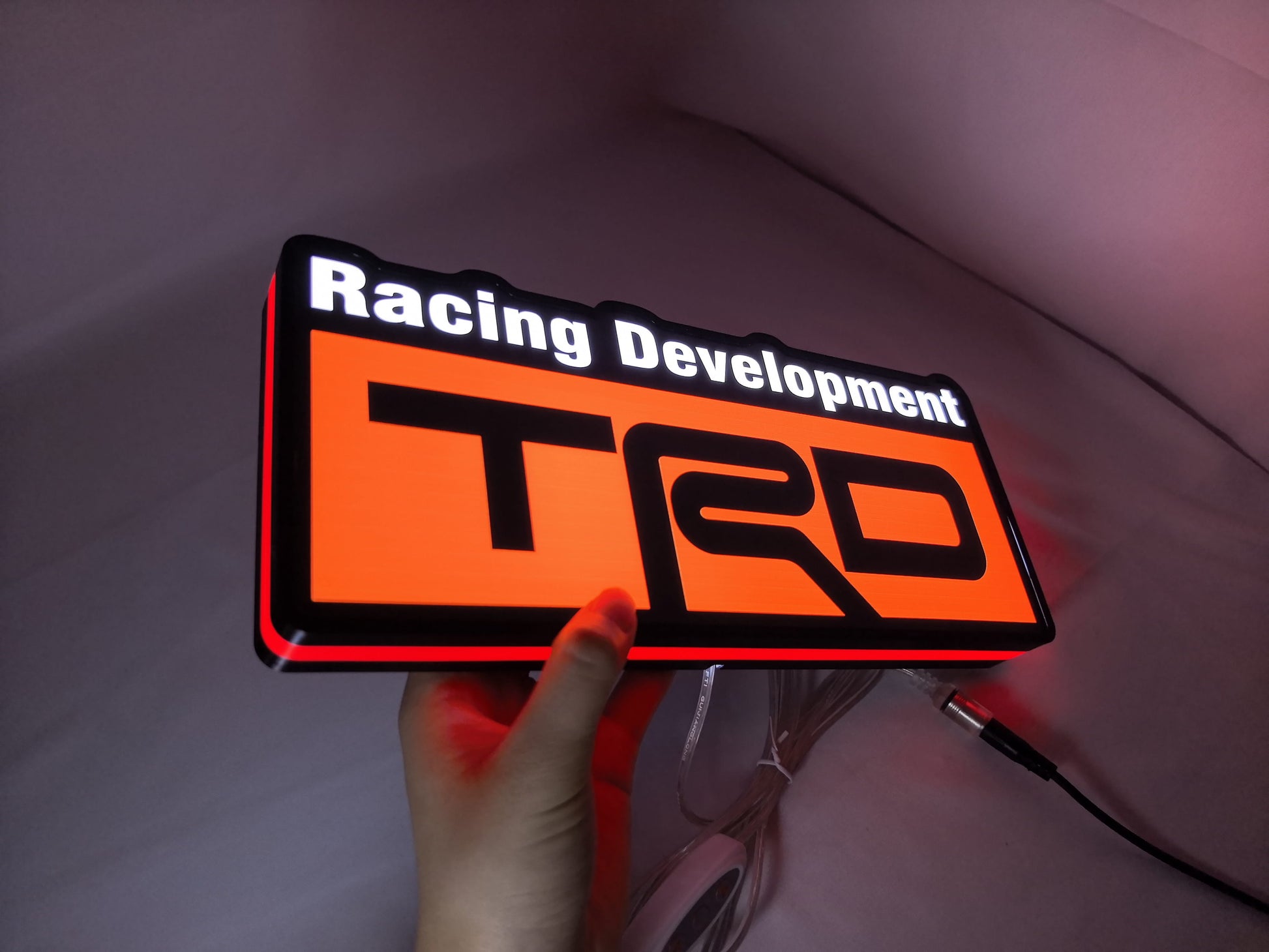Illuminated handheld size reference of Trd Racing Development 3D LED Sign in 30cm, perfect for garage and man cave decor
