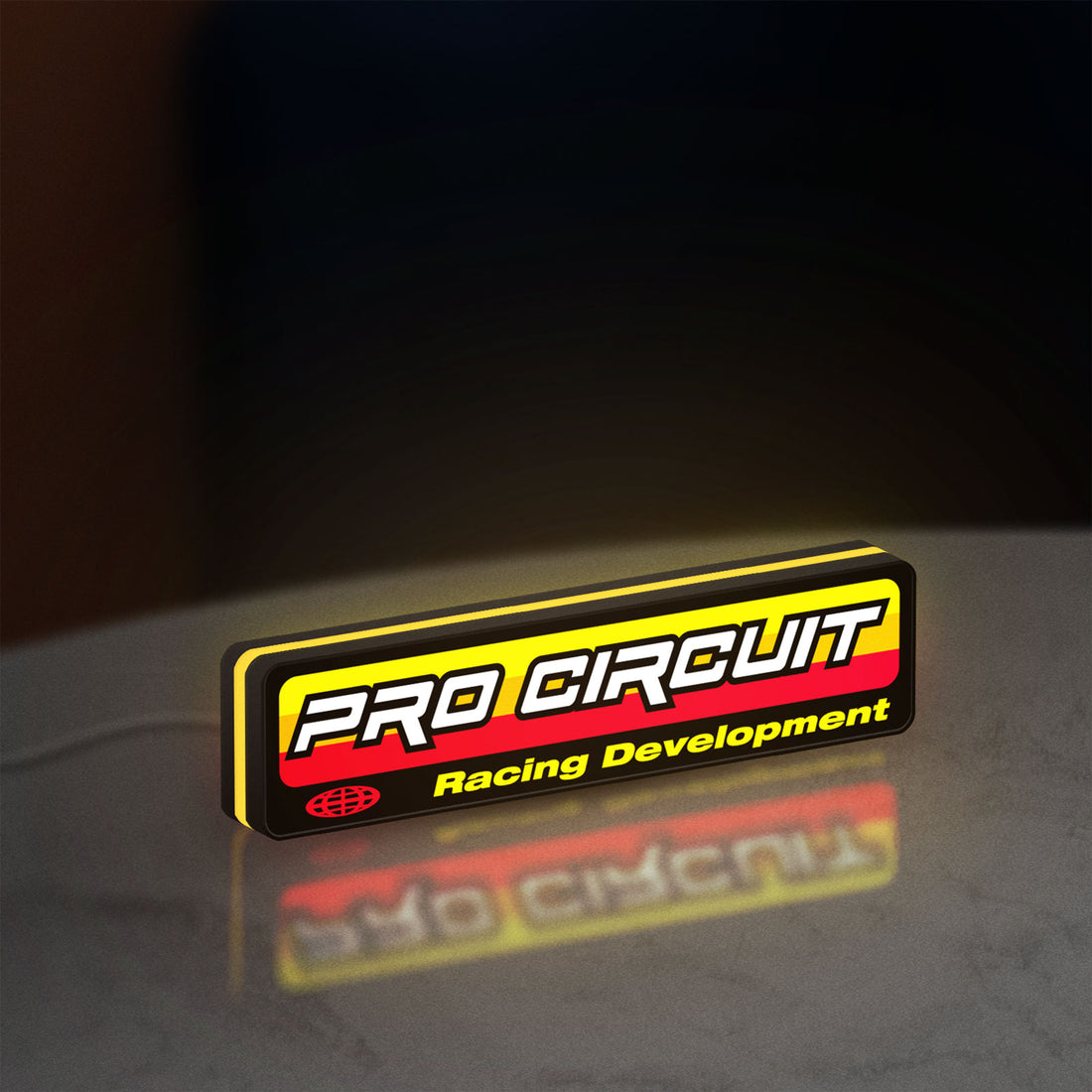 Pro Circuit Racing Development LED lightbox hanging on a wall with yellow glow