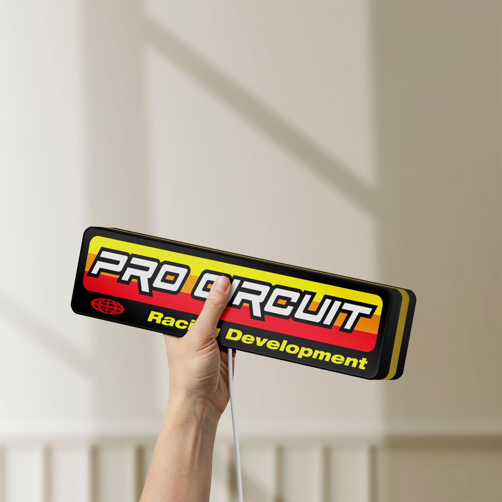 Unlit Pro Circuit Racing Development LED lightbox held by hand to show size and details