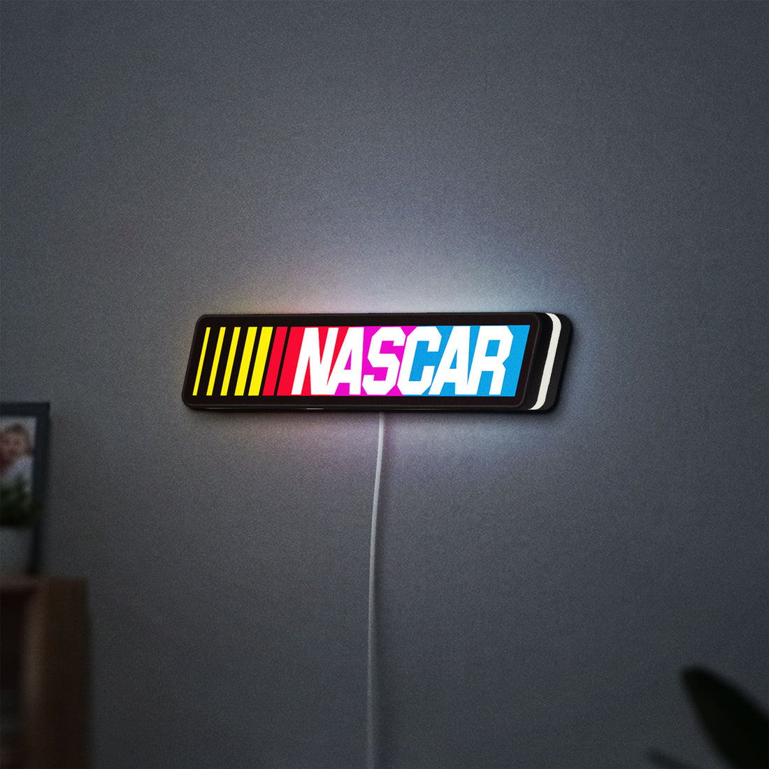 NASCAR LED lightbox hanging on a wall with white glow