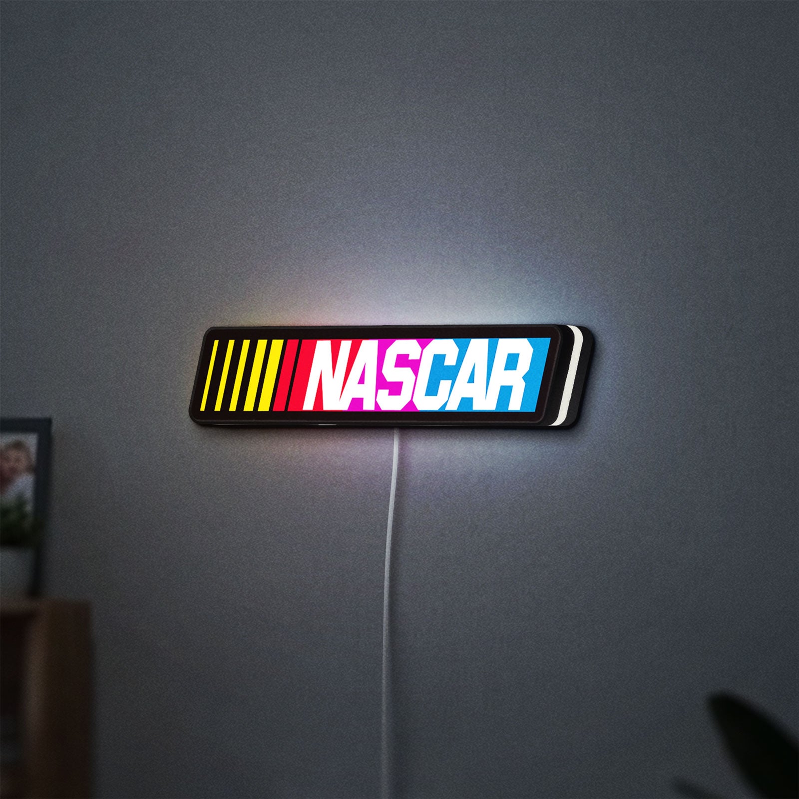 NASCAR LED lightbox hanging on a wall with white glow