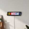 Unlit NASCAR LED lightbox mounted on a wall in daylight