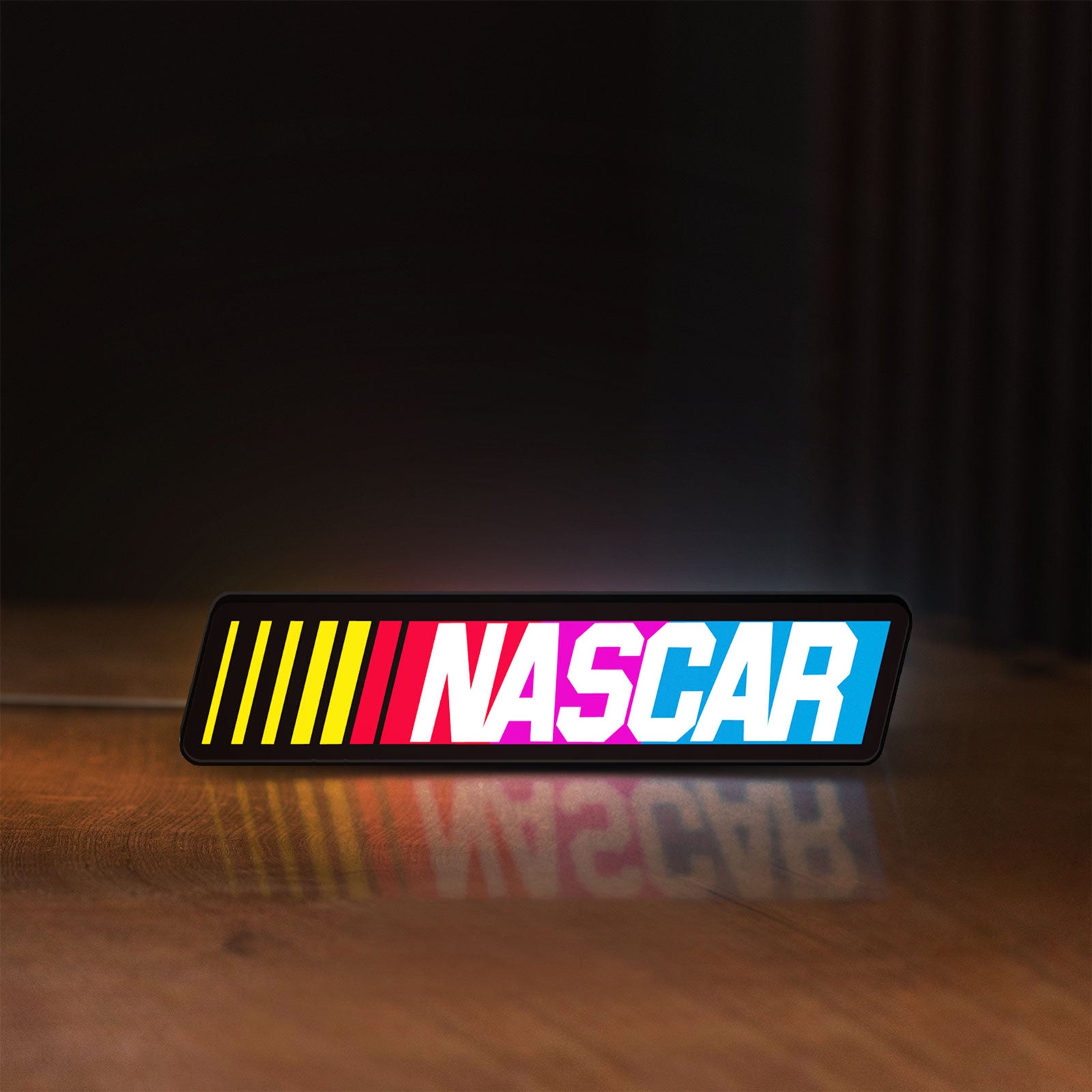 Front view of NASCAR LED lightbox sign glowing on a wooden desk