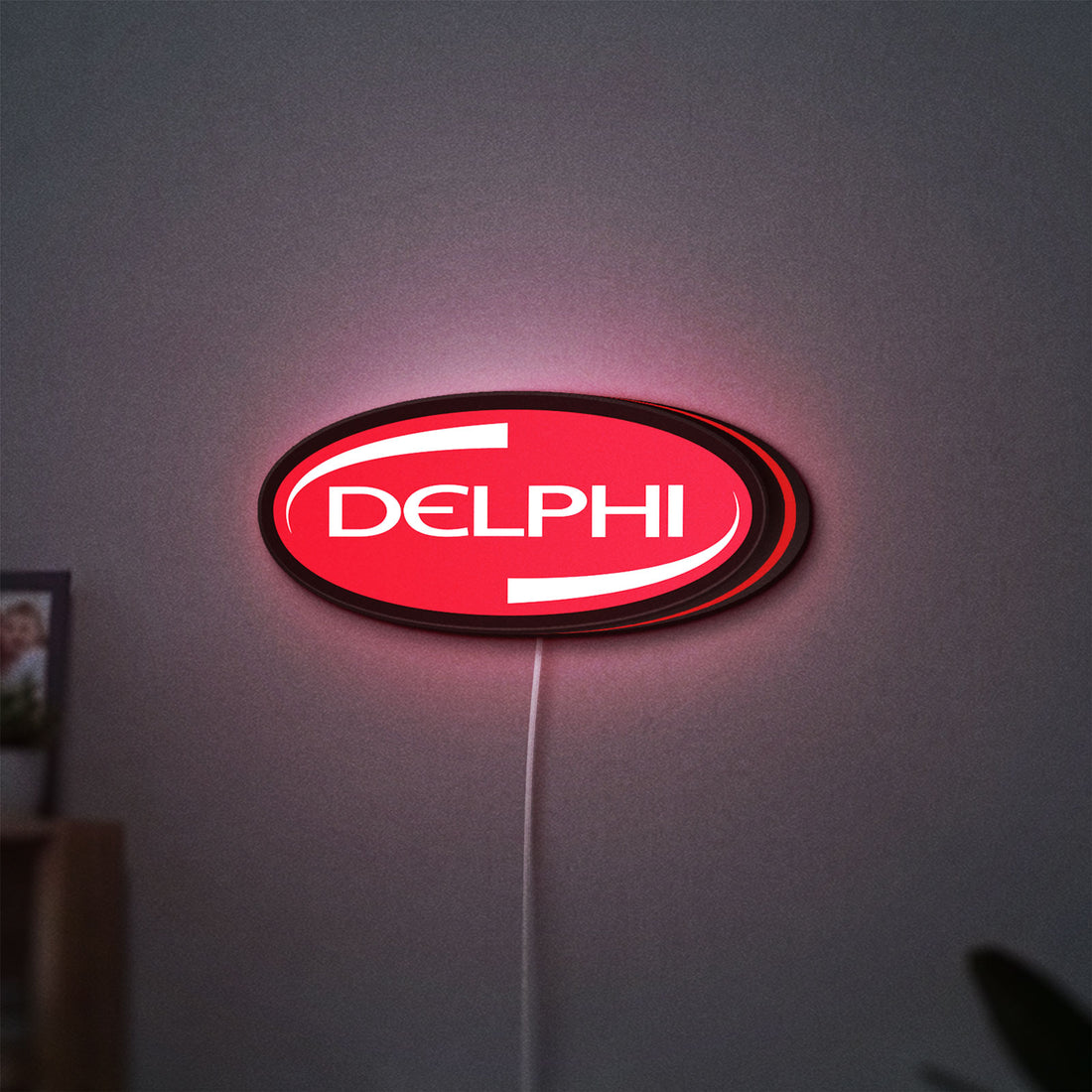 Delphi LED lightbox hanging on a wall with red glow