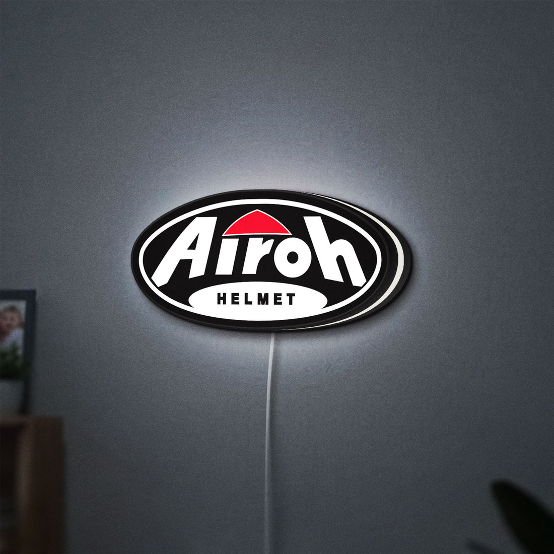 Airoh Helmet LED lightbox hanging on a wall with white glow
