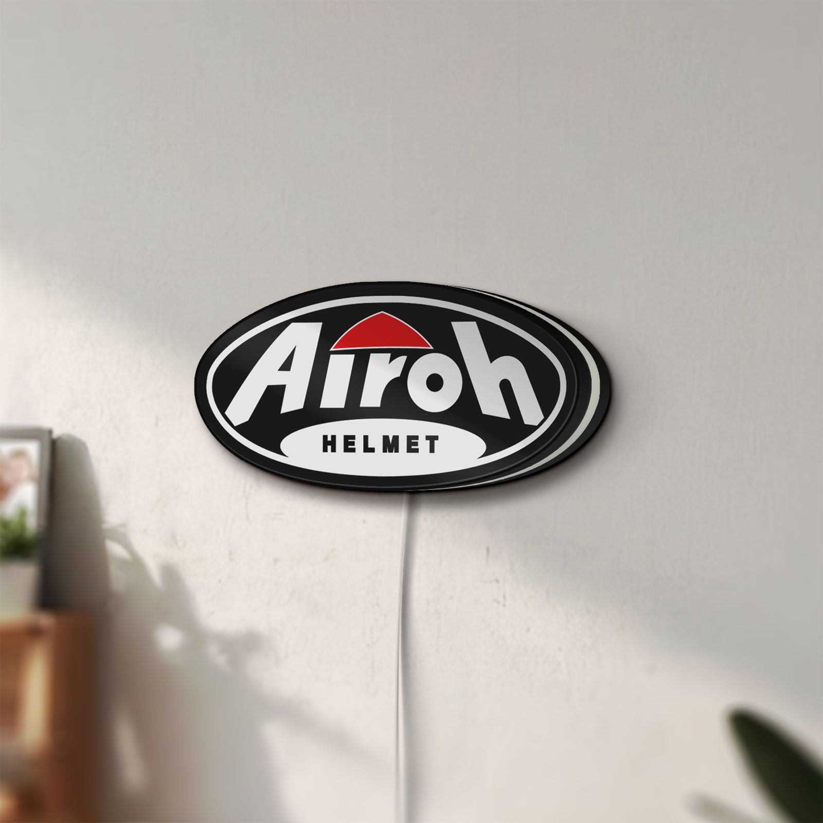 Unlit Airoh Helmet LED lightbox mounted on a wall in daylight