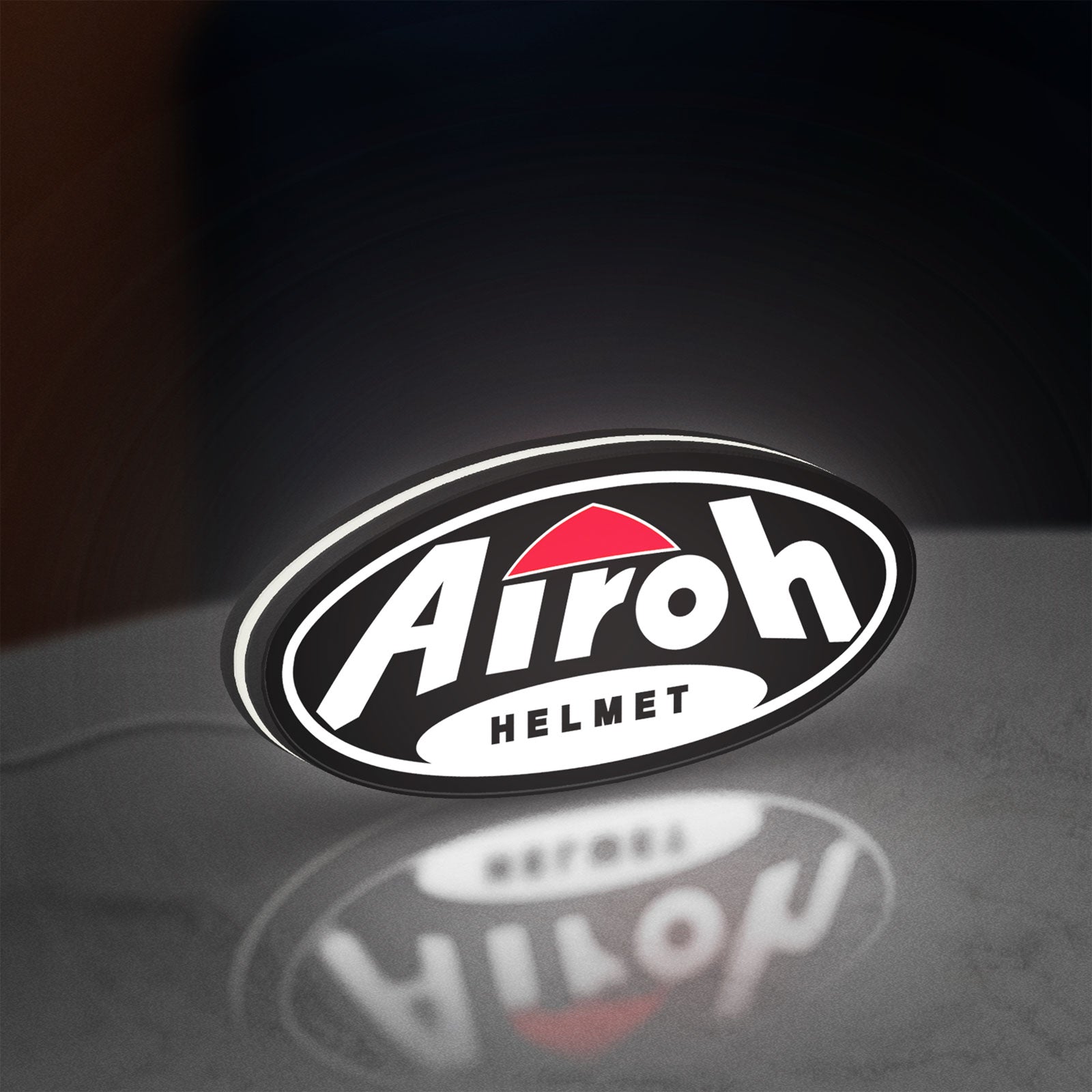 Airoh Helmet LED lightbox standing on a desk from an angled side view with white glow