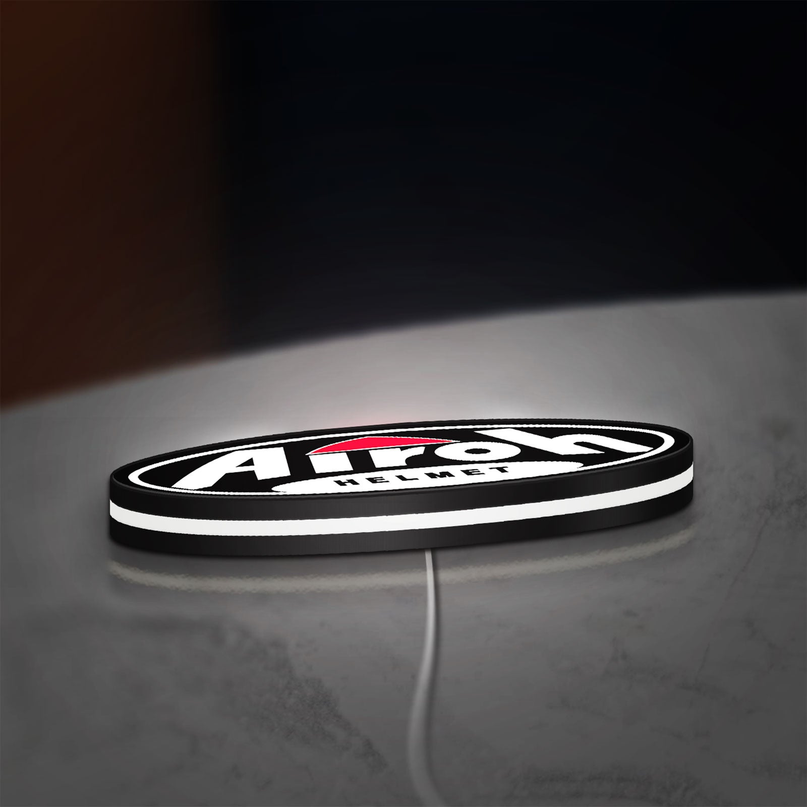 Airoh Helmet LED lightbox lying flat on a desk with white glow
