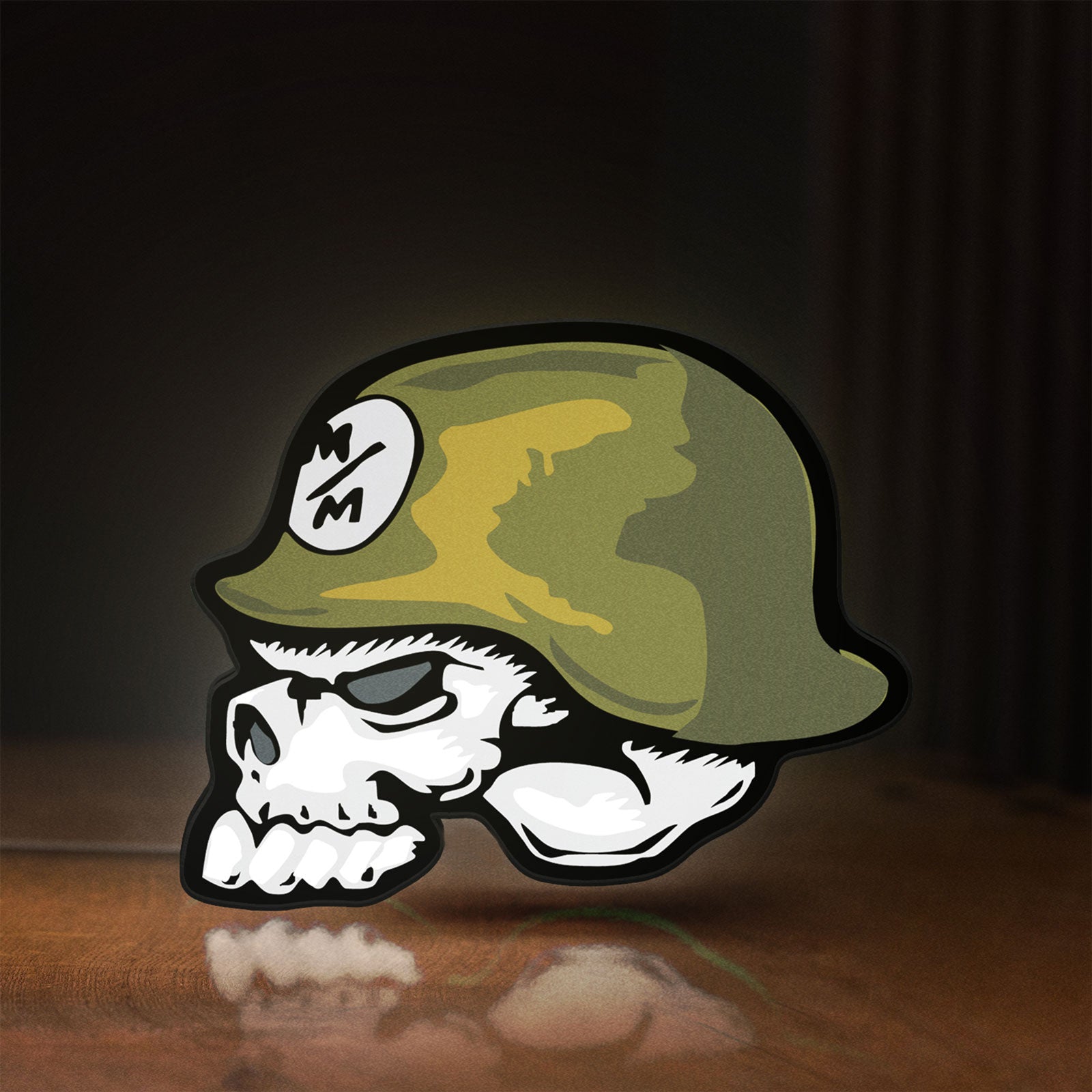 Front view of Metal Mulisha Skull LED lightbox sign glowing on a wooden desk