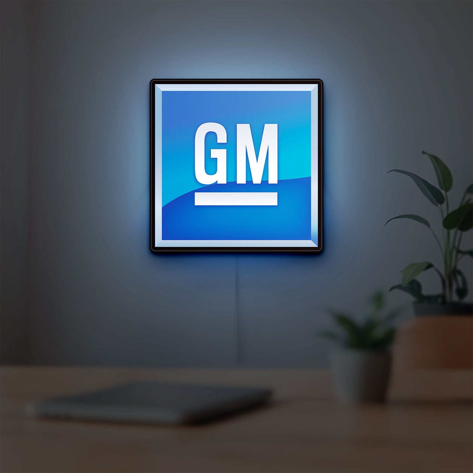 GM LED lightbox hanging on a room wall with soft blue light