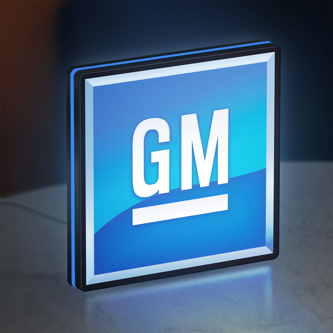 GM LED lightbox hanging on a wall with blue glow