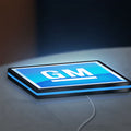 GM LED lightbox lying flat on a desk with blue glow