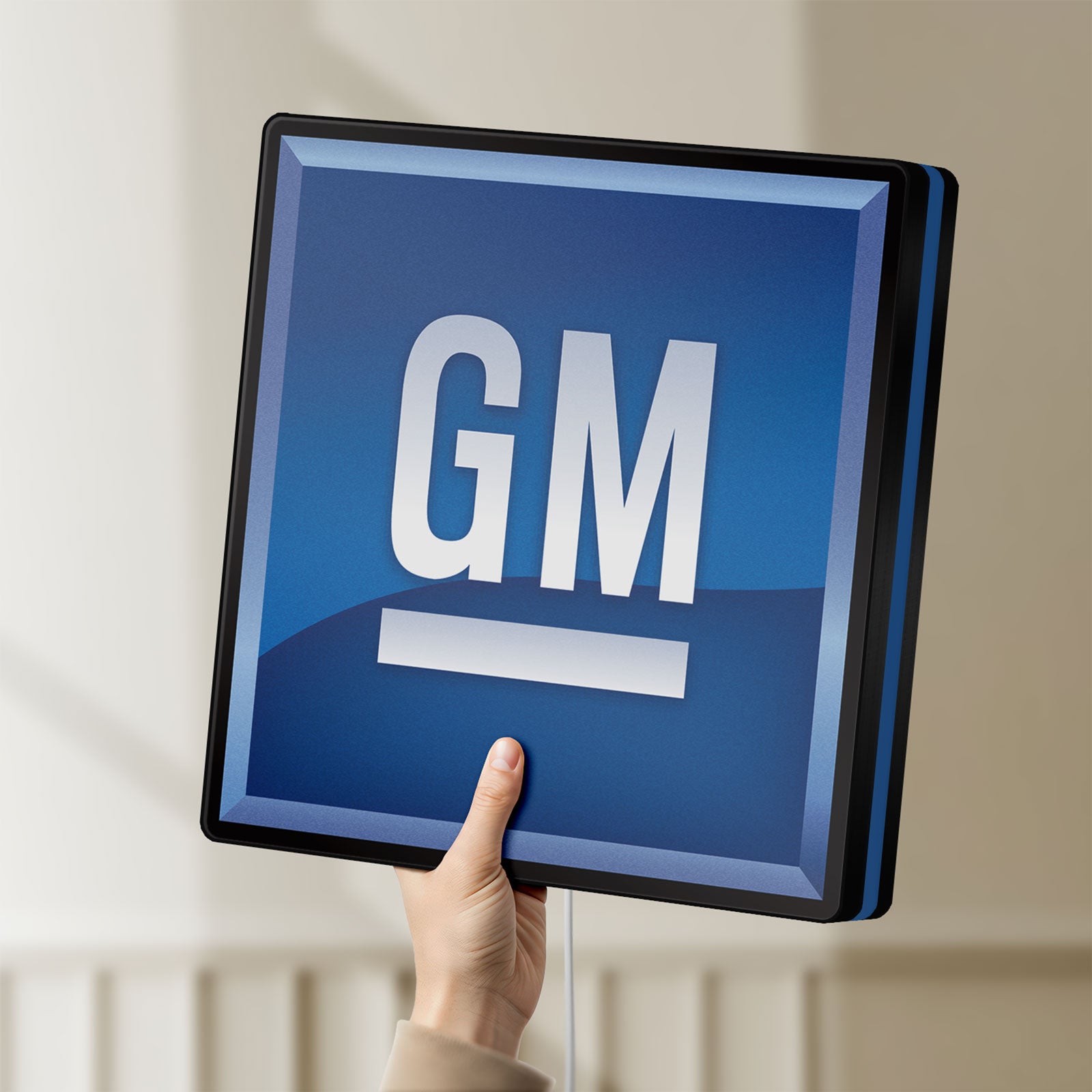 Unlit GM LED lightbox held by hand to show size and details