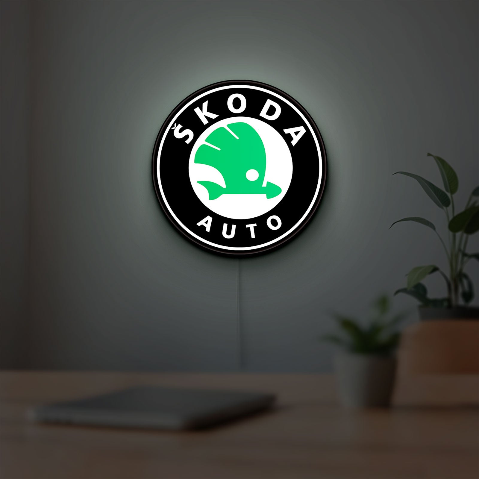 Skoda LED lightbox hanging on a room wall with soft green light