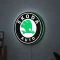 Skoda LED lightbox hanging on a wall with green glow