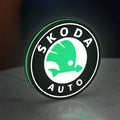Skoda LED lightbox standing on a desk from an angled side view with green glow