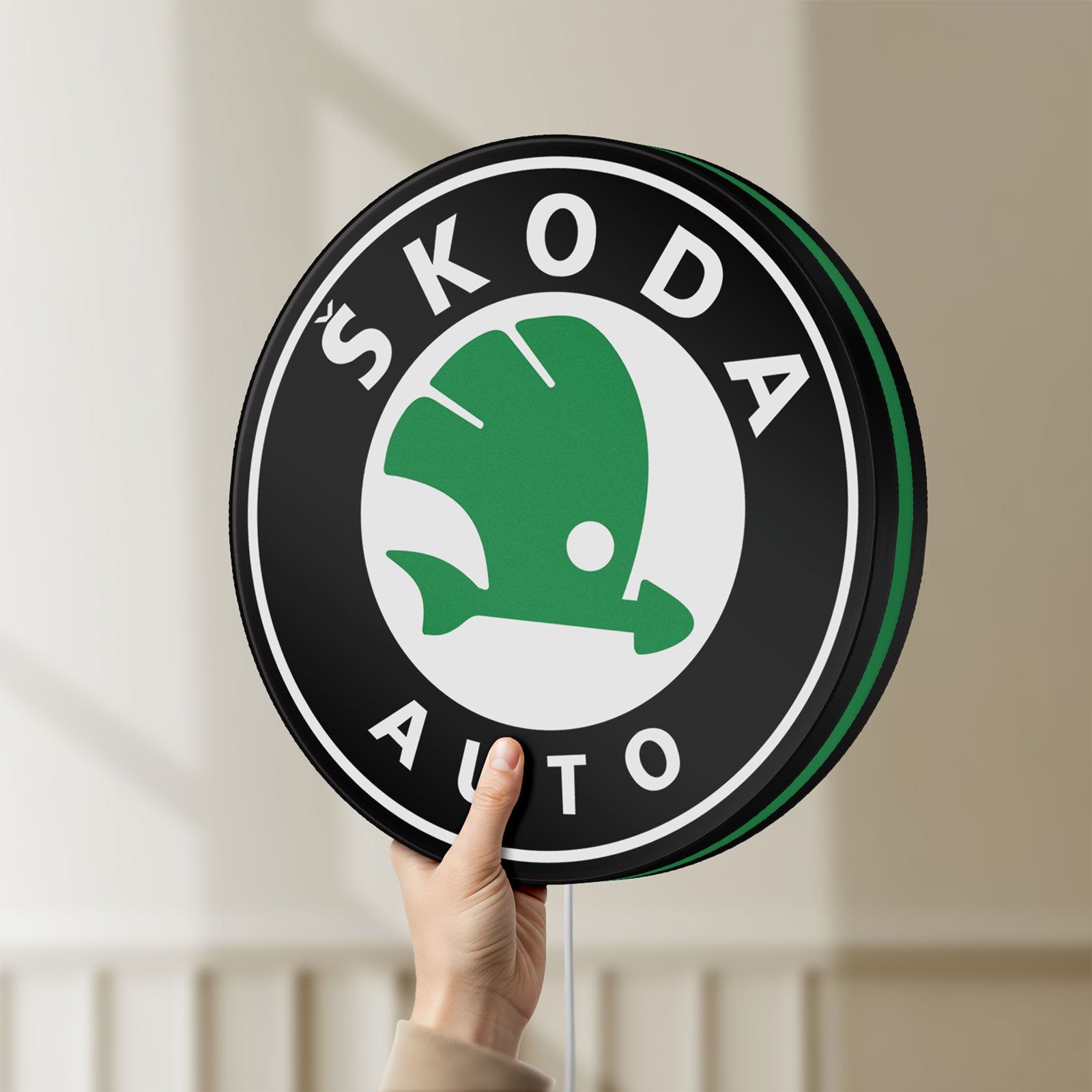 Unlit Skoda LED lightbox held by hand to show size and details