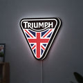 Triumph LED lightbox hanging on a wall with white glow