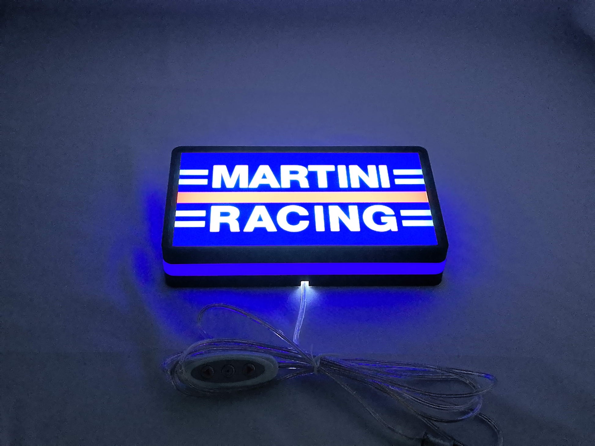Illuminated flat lay angled view of Martini Racing 3D LED Sign in 20cm, perfect for garage and man cave decor