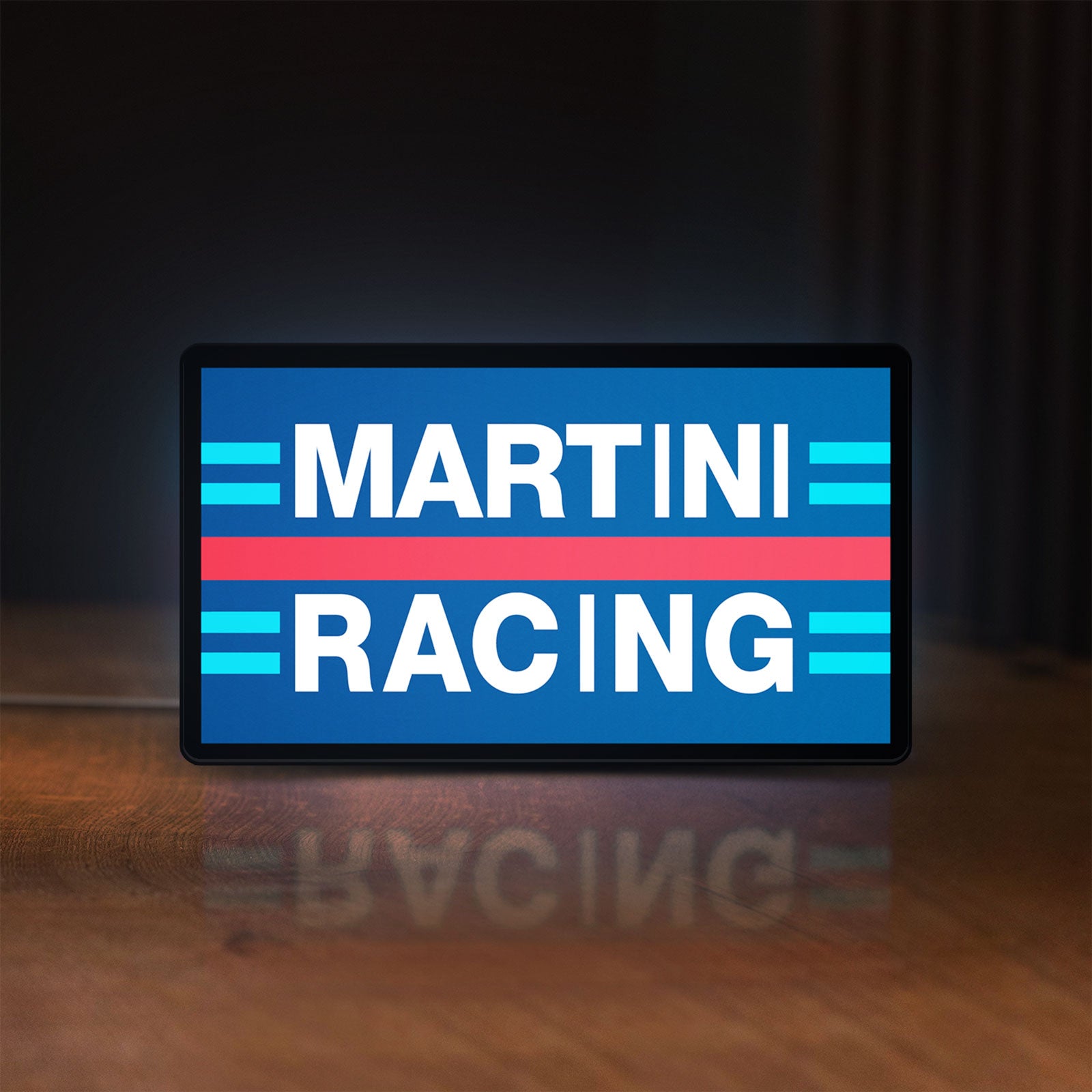 Front view of Martini Racing LED lightbox sign glowing on a wooden desk