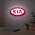 KIA LED lightbox hanging on a room wall with soft red light