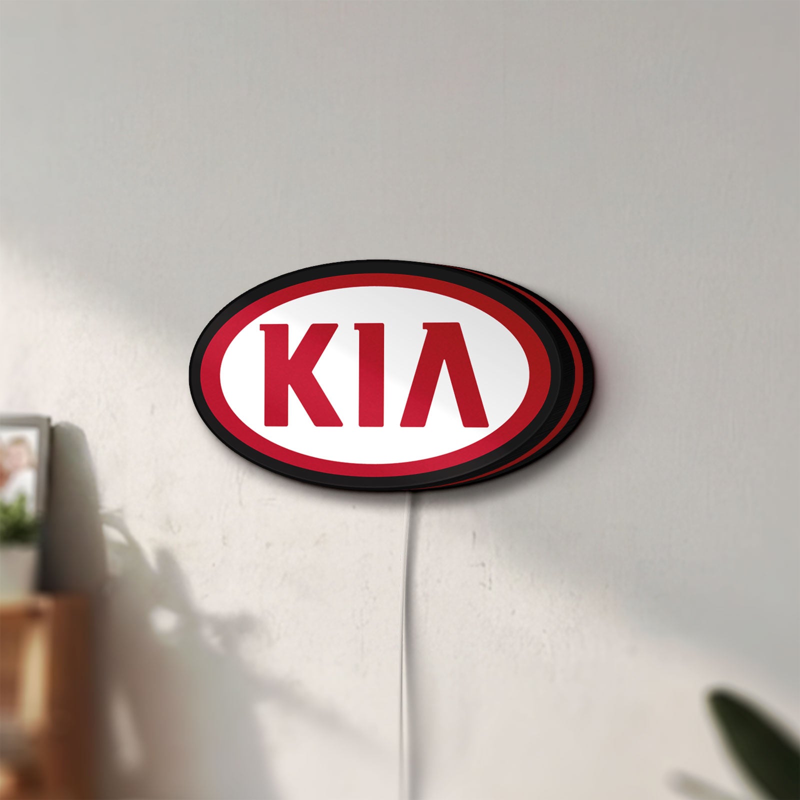 Unlit KIA LED lightbox mounted on a wall in daylight
