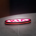 KIA LED lightbox lying flat on a desk with red glow