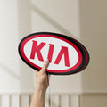 Unlit KIA LED lightbox held by hand to show size and details