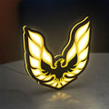 Pontiac Firebird 1977 LED lightbox standing on a desk from an angled side view with yellow glow