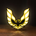 Front view of Pontiac Firebird 1977 LED lightbox sign glowing on a wooden desk