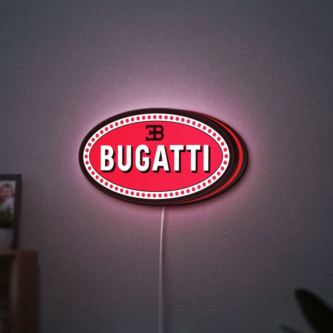 Bugatti LED lightbox hanging on a wall with red glow