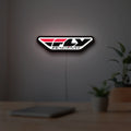 Fly Racing LED lightbox hanging on a room wall with soft white light