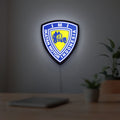 Ikatan Motor Indonesia LED lightbox hanging on a room wall with soft white light