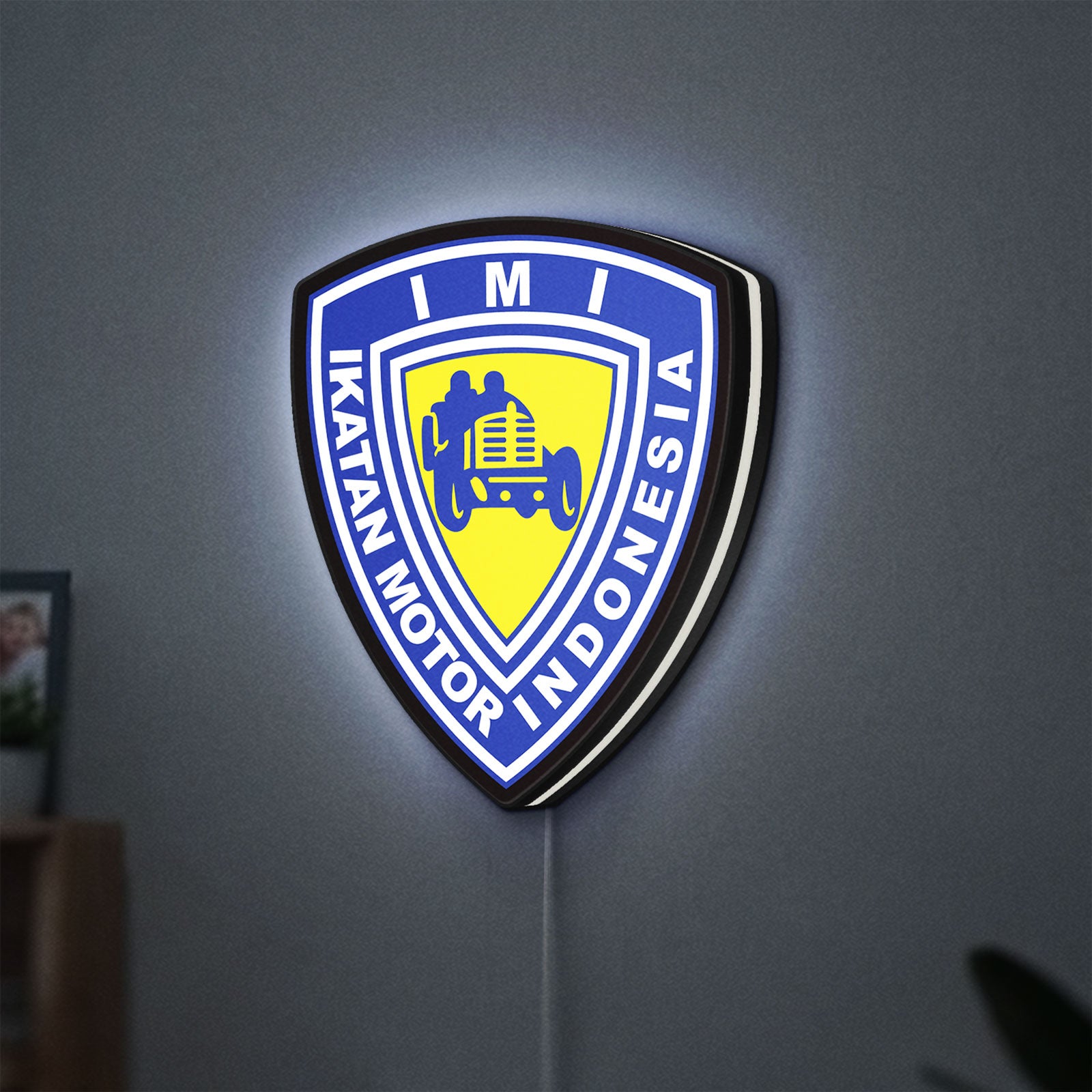 Ikatan Motor Indonesia LED lightbox hanging on a wall with white glow