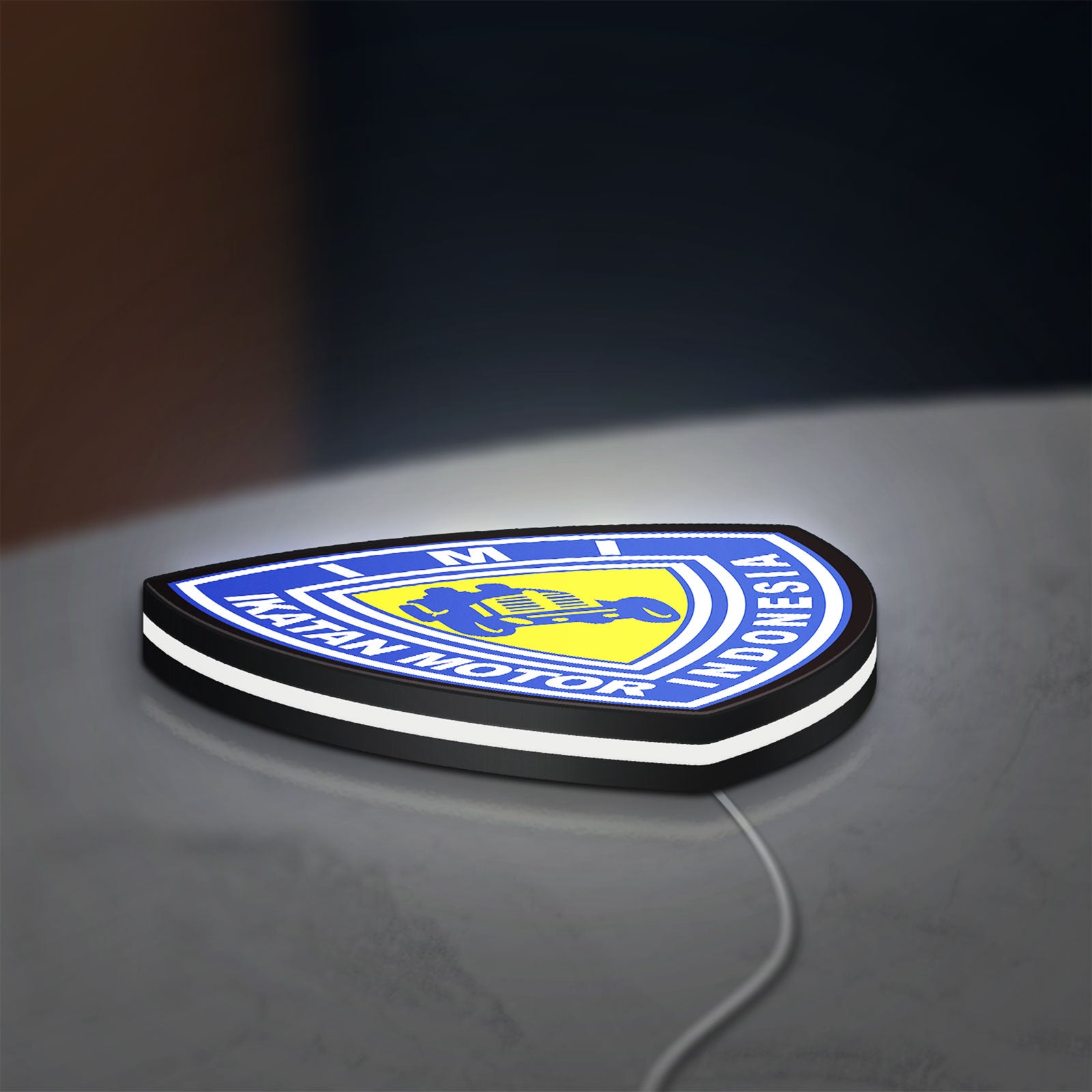 Ikatan Motor Indonesia LED lightbox lying flat on a desk with white glow