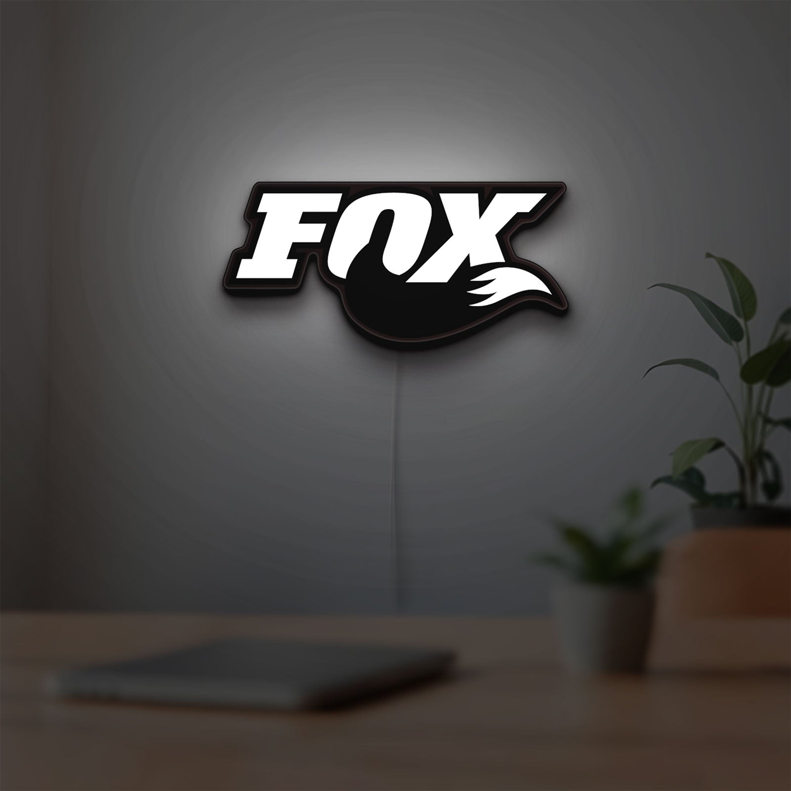 FOX Racing LED lightbox hanging on a room wall with soft white light