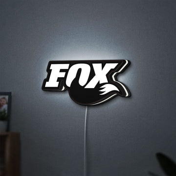 FOX Racing LED lightbox hanging on a wall with white glow