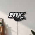 Unlit FOX Racing LED lightbox mounted on a wall in daylight