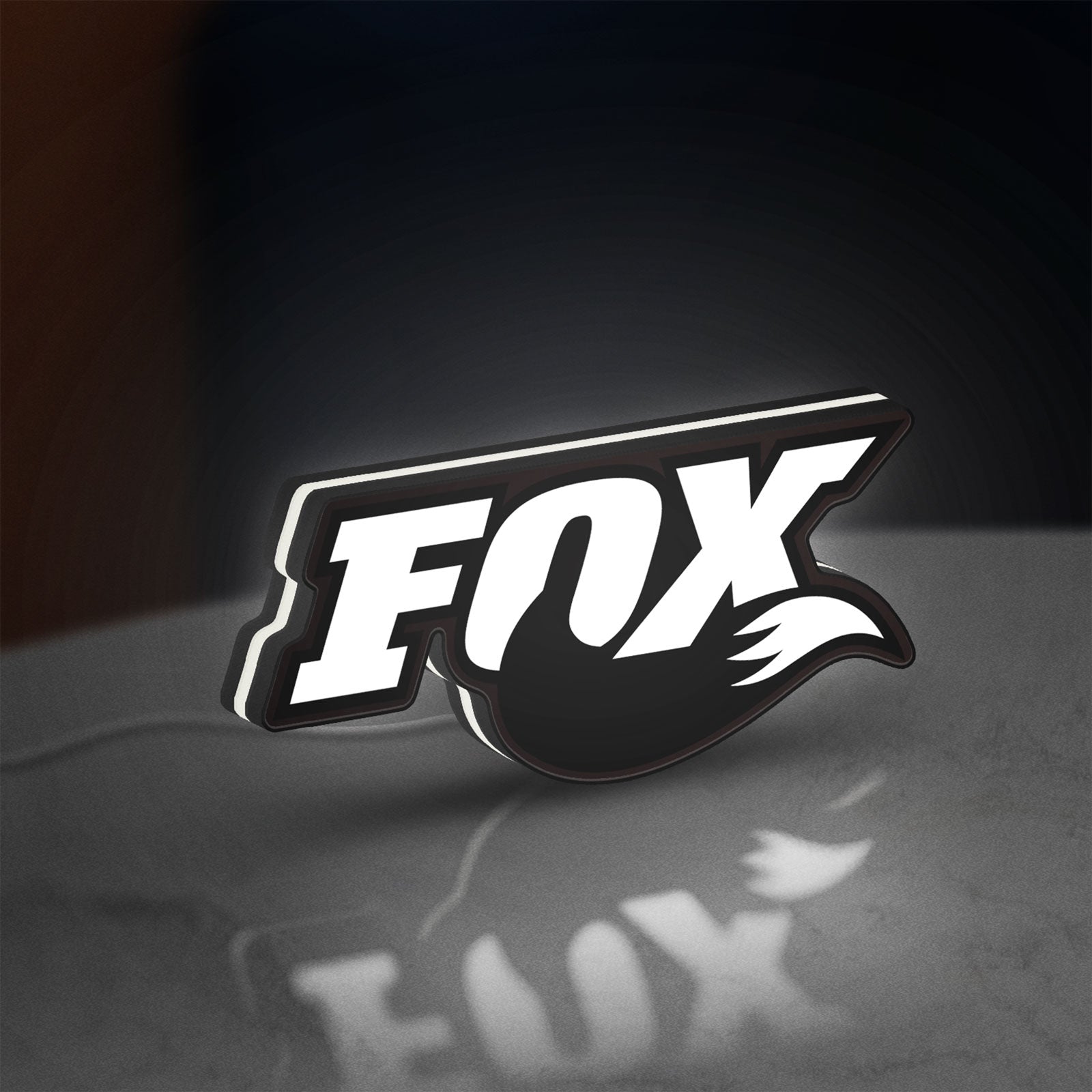 FOX Racing LED lightbox standing on a desk from an angled side view with white glow