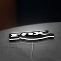 FOX Racing LED lightbox lying flat on a desk with white glow