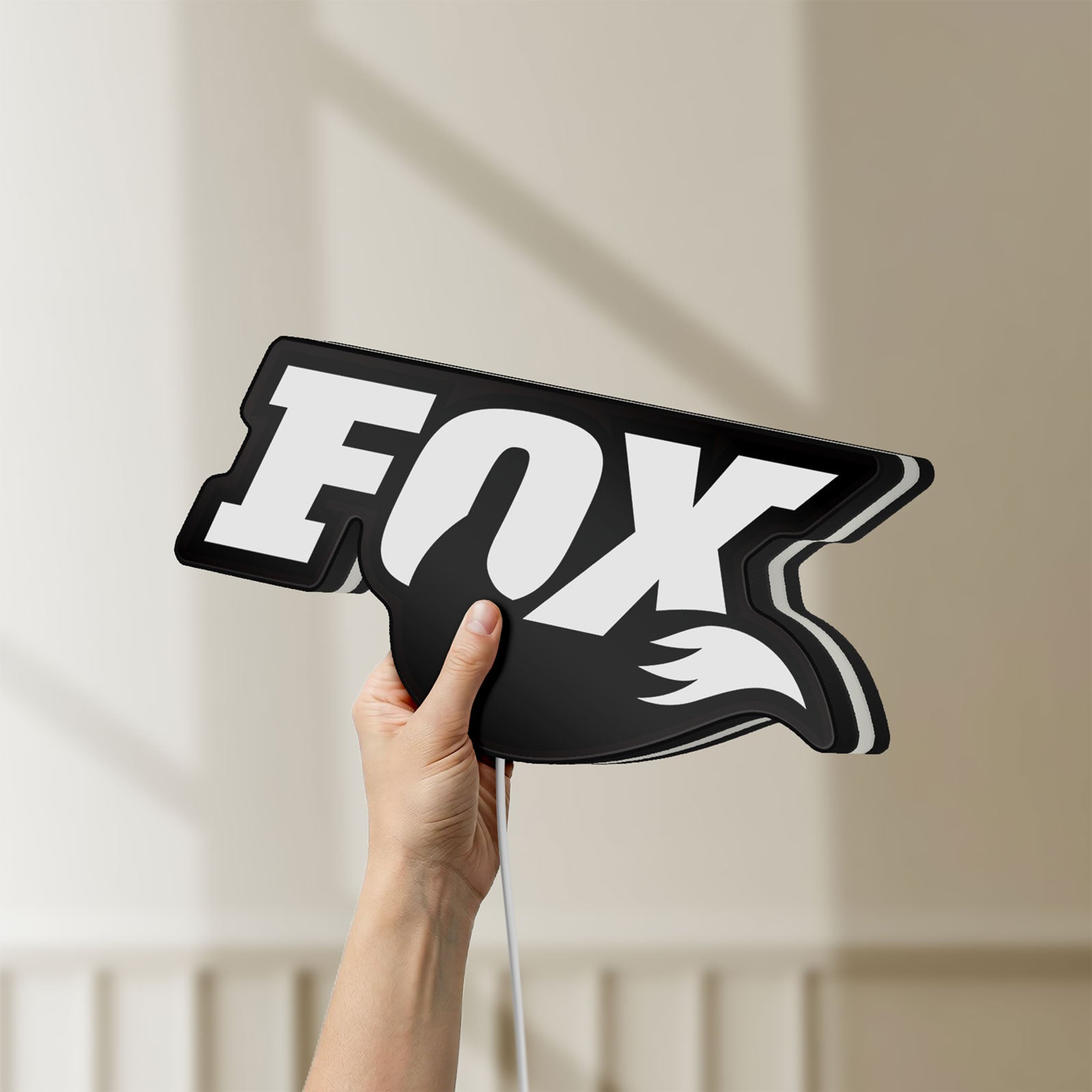 Unlit FOX Racing LED lightbox held by hand to show size and details