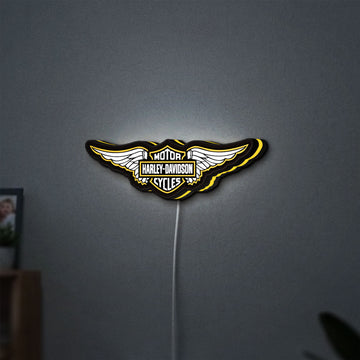 Harley Davidson Wings LED lightbox hanging on a wall with yellow glow